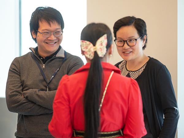 Three colleagues conversing in an office