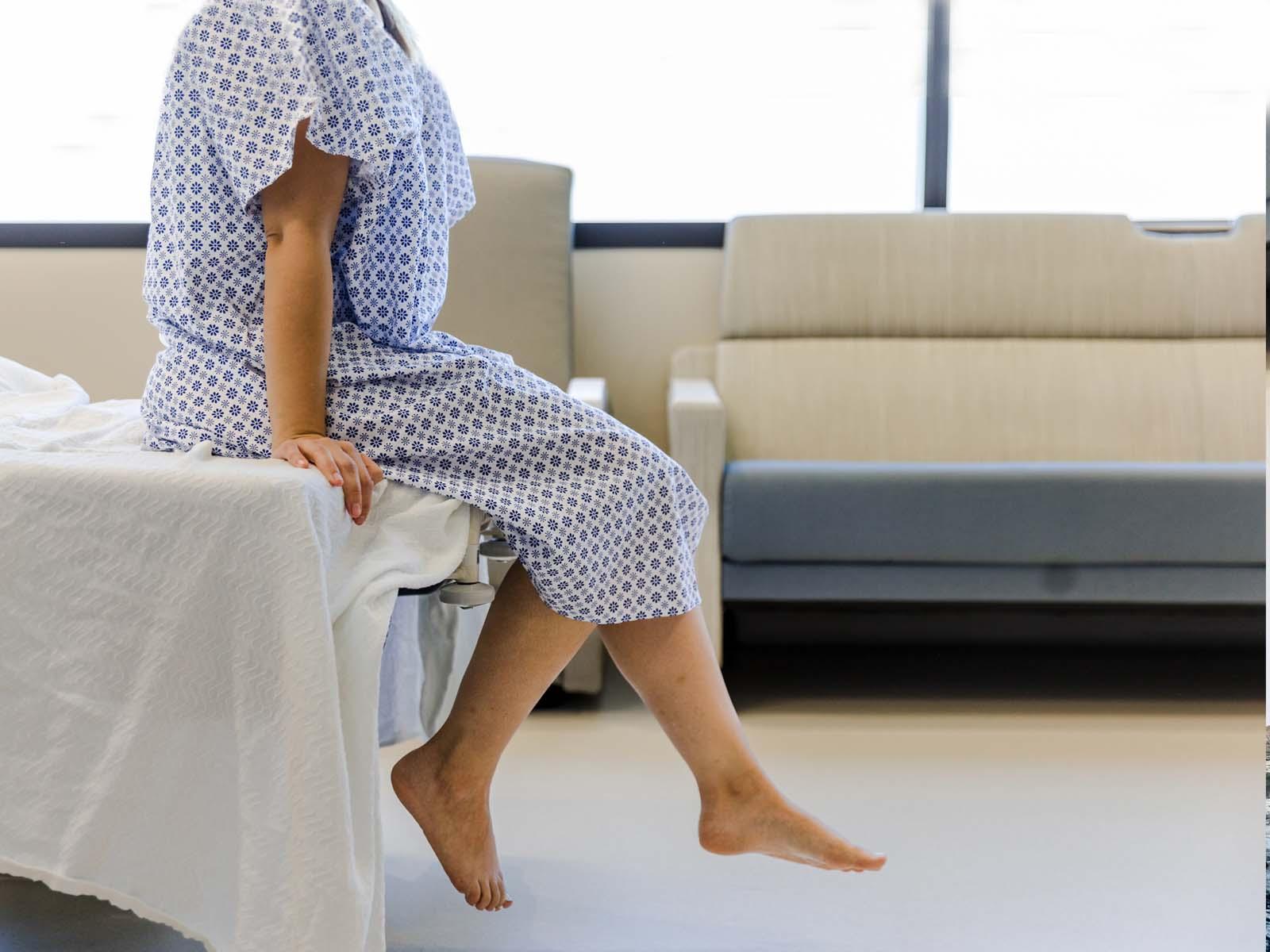 Woman sitting on hospital bed