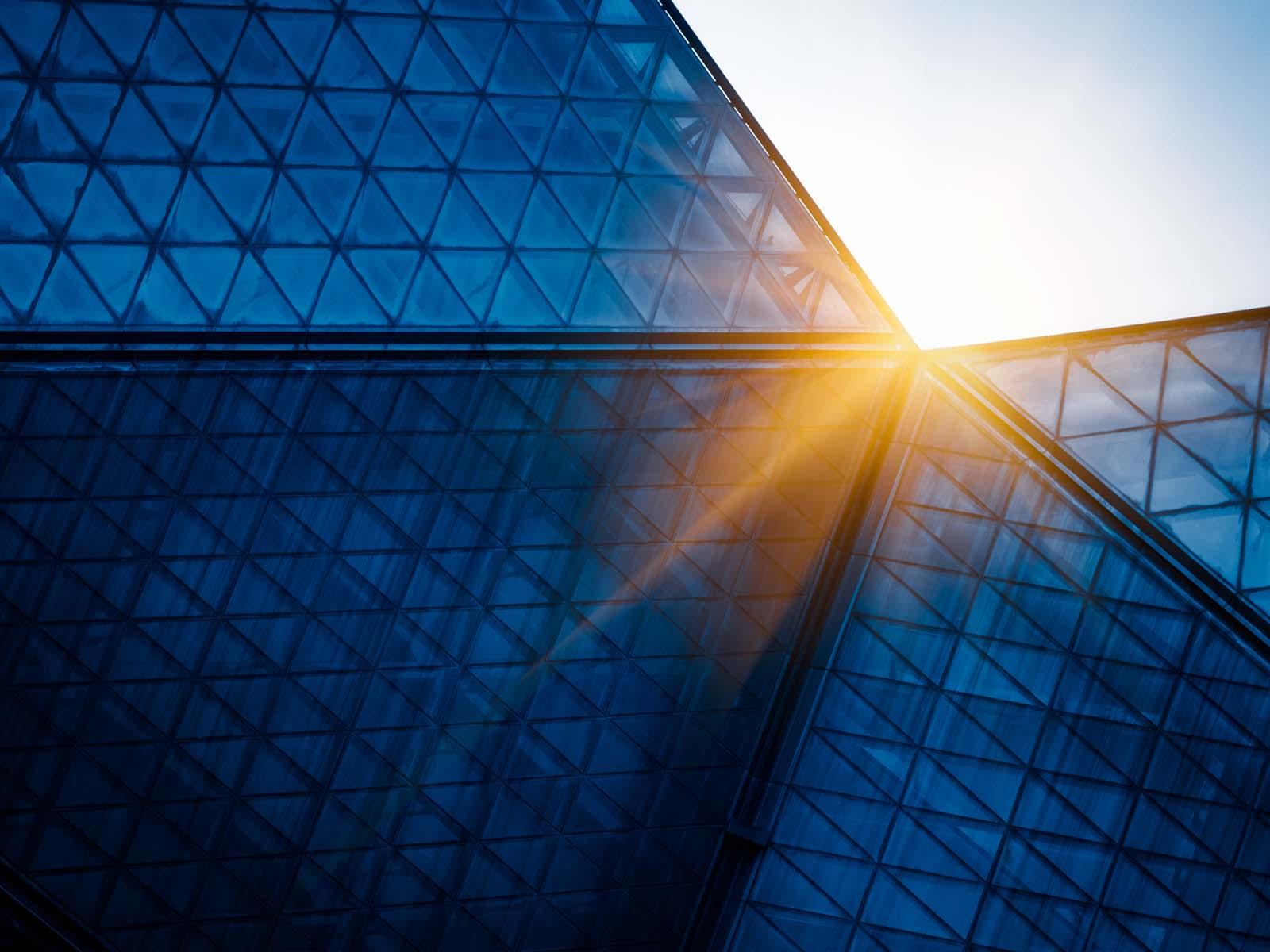 Sun setting over modern building